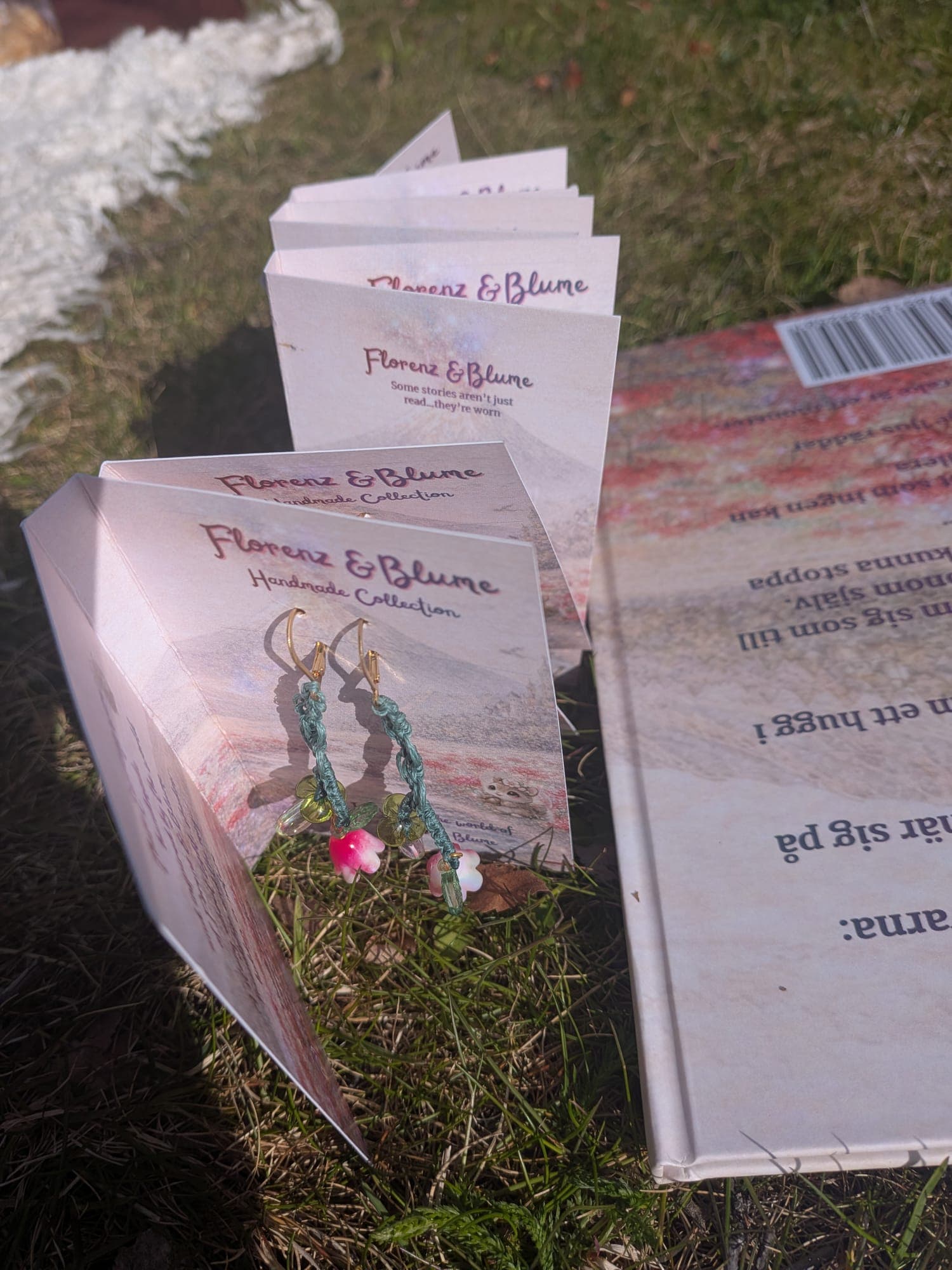 The flower earrings laid out in the grass