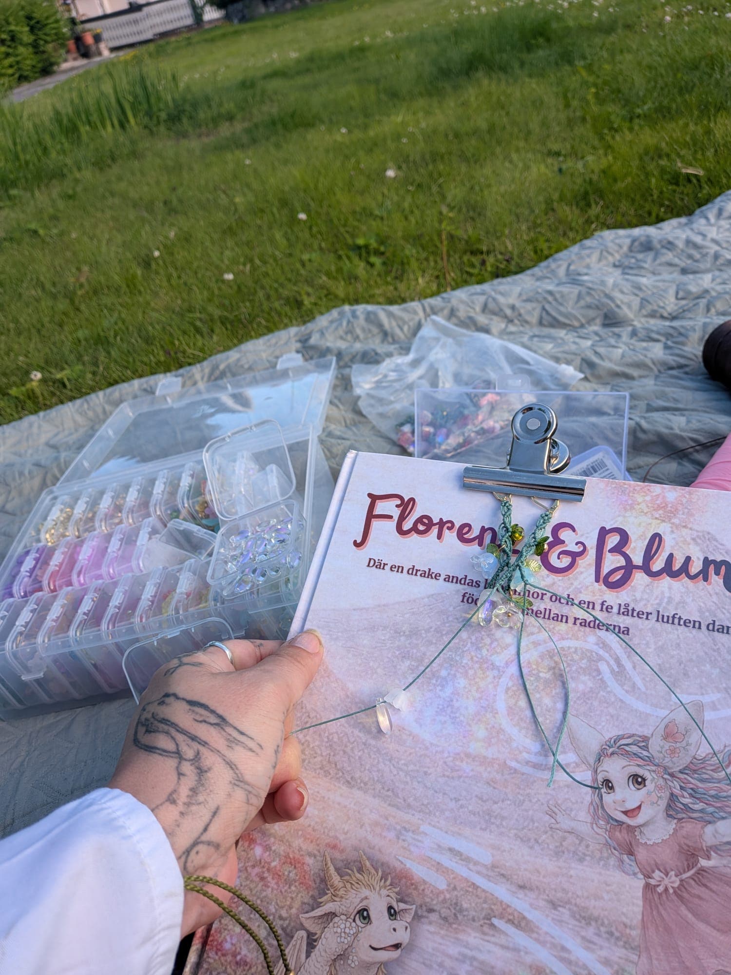 Bracelets being knotted on a blanket in the grass