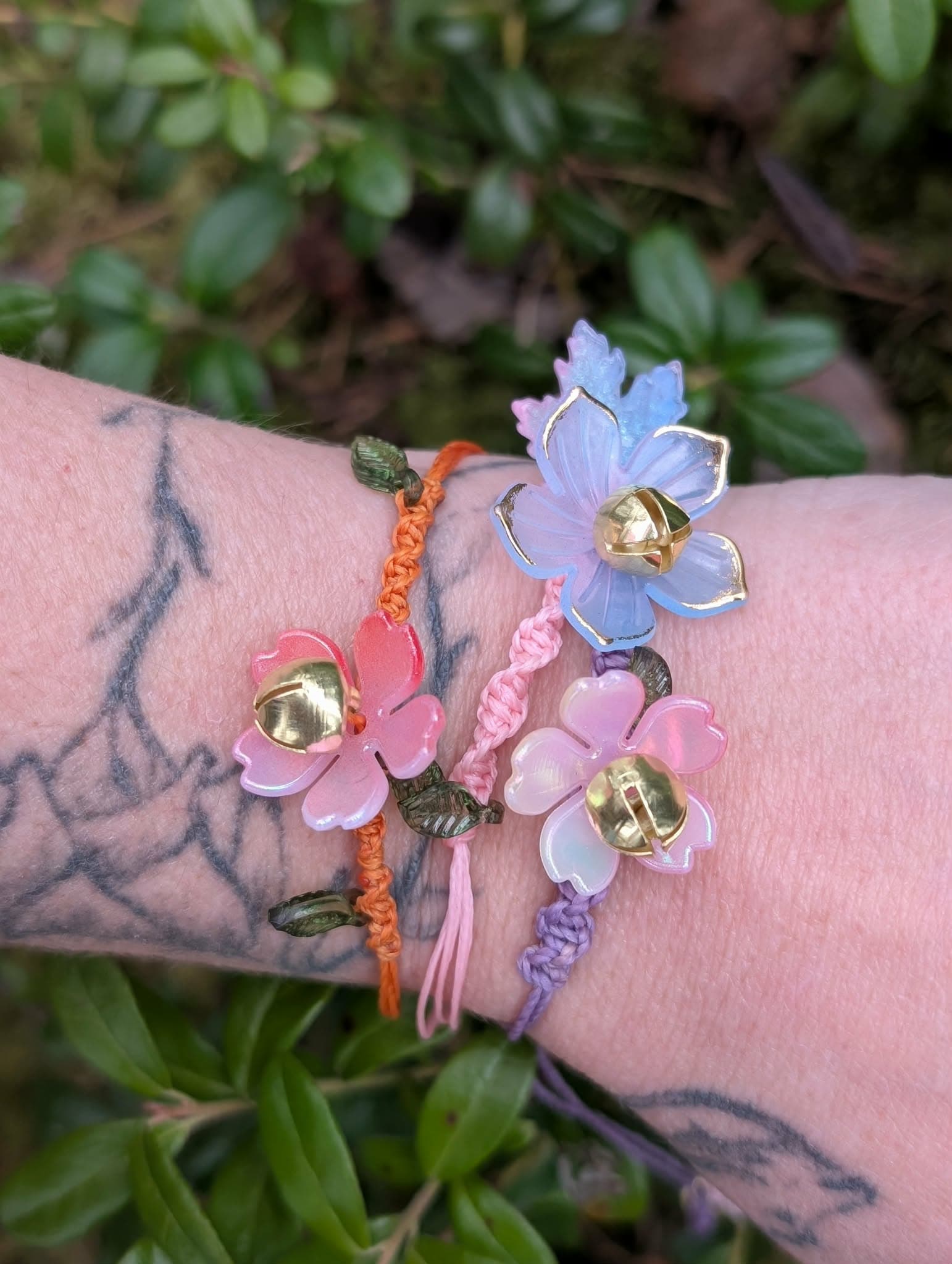 The flower bracelets worn on three wrists
