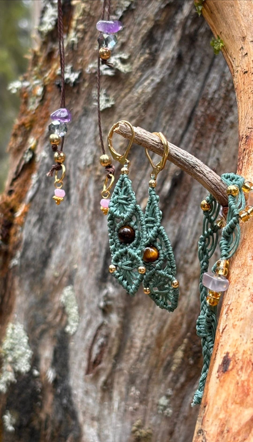 Macramé earrings resting on bark