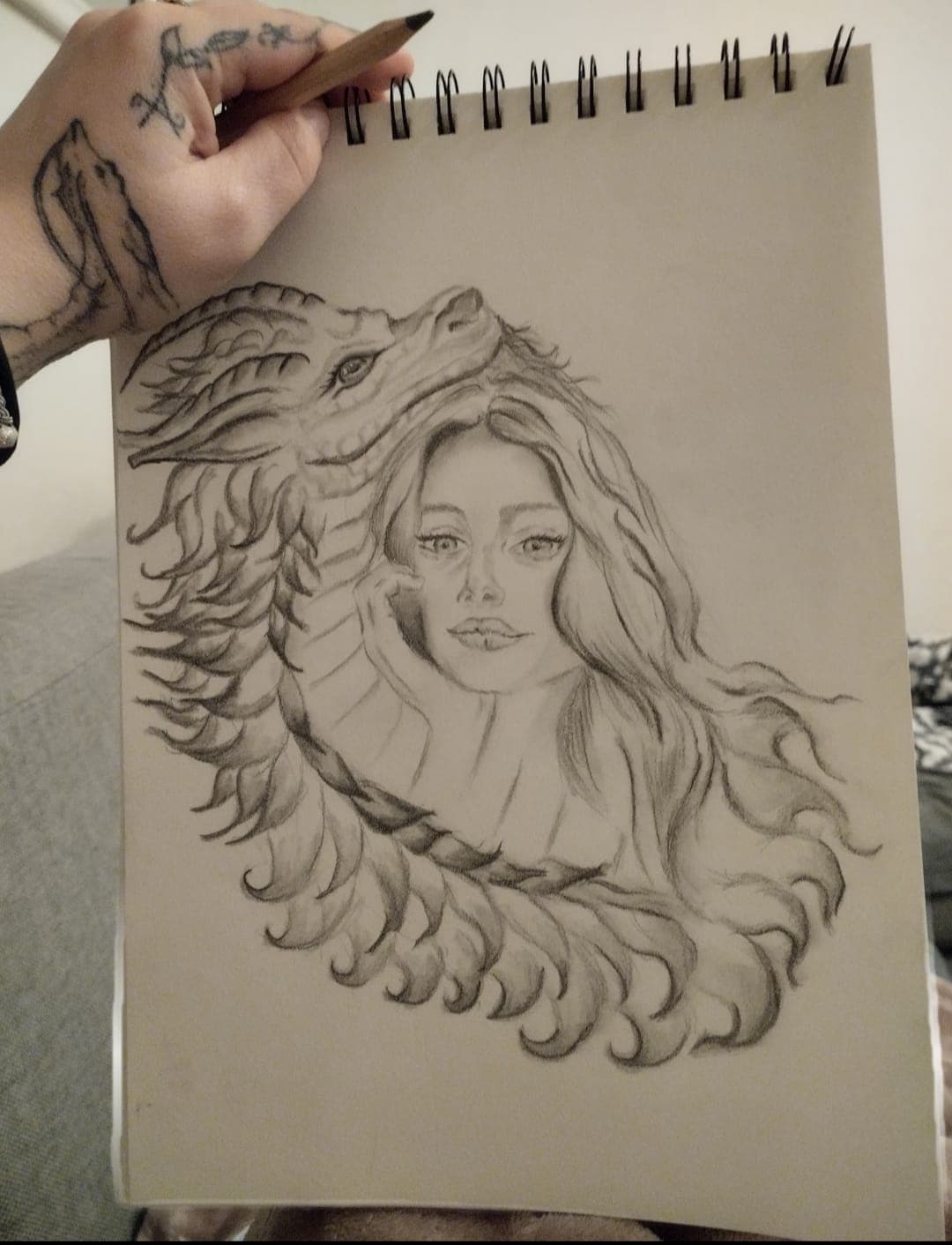 Large pencil drawing of a girl framed by a dragon curling around her